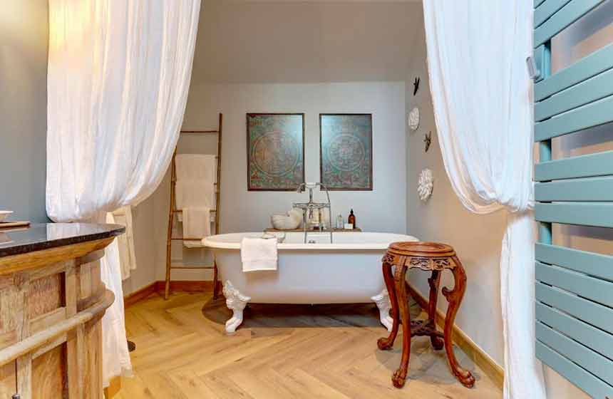 The chic bathroom contains a classic claw-footed freestanding bathtub 