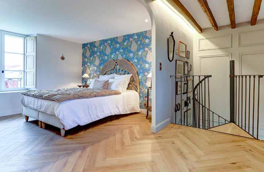 The warm and inviting bedroom upstairs complete with luxury linen bedding