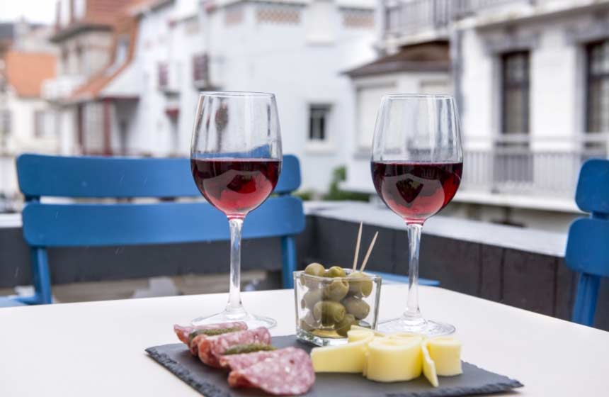 An aperitif of cheese and wine on the balcony