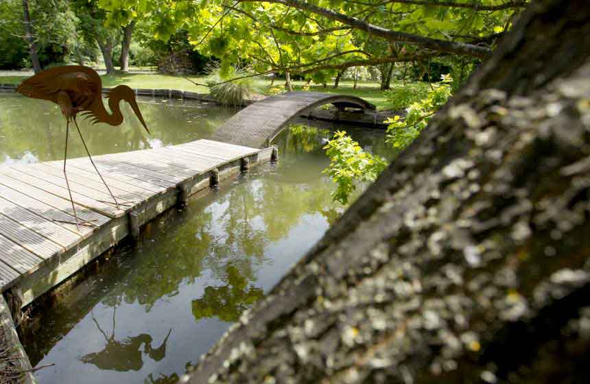 The pretty bridge and small island in the garden of your Amiens holiday cottage