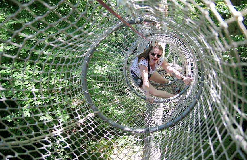 Working your way from tree to tree, enjoy the treetops adventure playground at Grimp à l'Arb