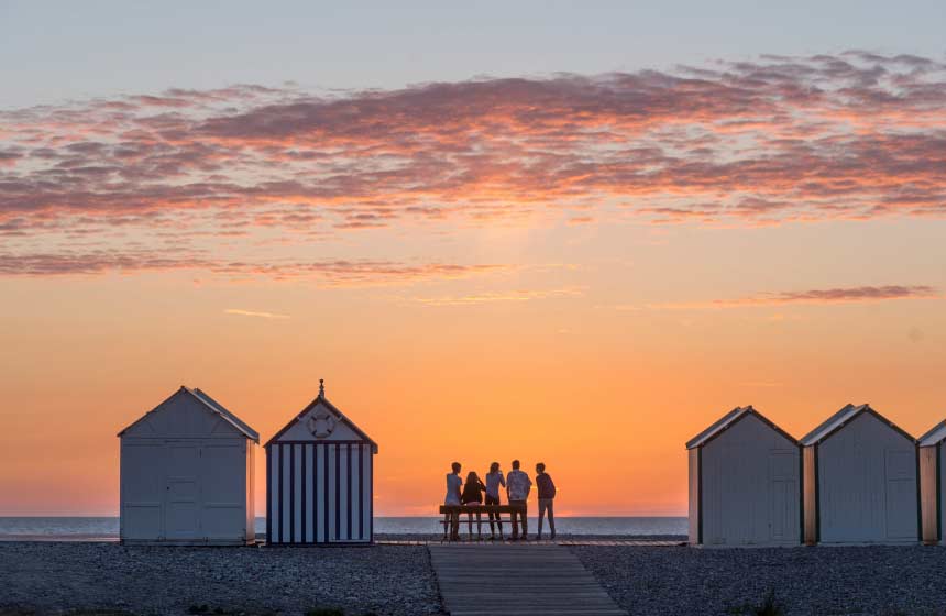 Beach-huts by the sea at sunset in Cayeux-sur-Mer, Northern France