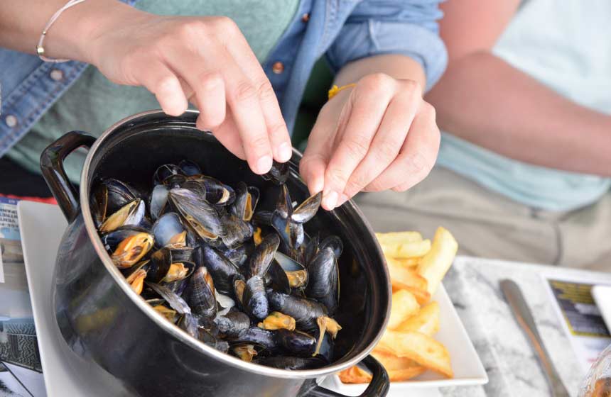 Trying the local speciality moules frites (mussels and chips) is a must on holiday in northern France