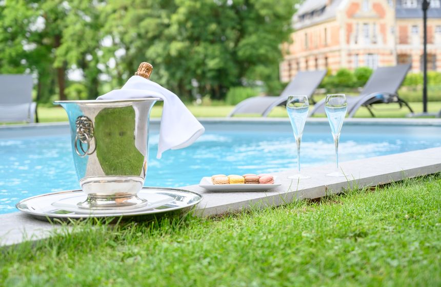 Enjoy a poolside a glass of champagne (or two) at Le Clos Barthélemy manor house in Northern France