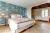The warm and inviting bedroom upstairs complete with luxury linen bedding