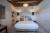 One of the bedrooms at Hôtel Le Chantilly oozing character and understated French elegance