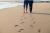 Walking barefoot on the fine sandy beach in Le Touquet, Northern France